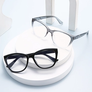 Ultralight retro cat eye glasses frames in black and gradient grey on geometric pedestals
