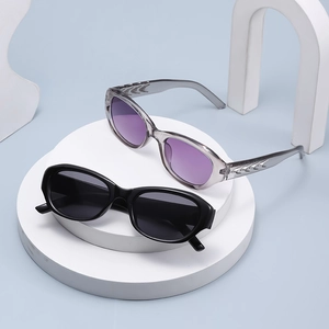 Modern cat-eye sunglasses in black and lavender tints on a minimalist blue backdrop