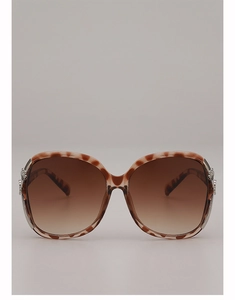 Detail view of large tortoise shell sunglasses featuring silver flower metal accents