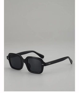 Detailed side view of black oversized square sunglasses with silver rivet accents
