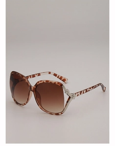 Detailed view of leopard print sunglasses featuring silver floral metal hinges and brown lenses