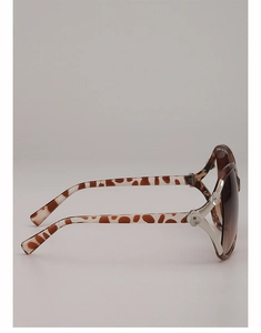 Detail of tortoiseshell sunglasses frame featuring silver flower hinge and brown gradient lens