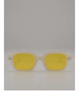 Close-up of translucent beige rectangle sunglasses with vibrant yellow lenses