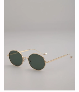 Detail of slim gold metal frame and dark green lenses on vintage round sunglasses