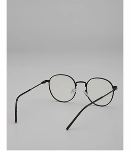 Macro view of retro black metal round frame glasses showing silicone nose pads and hinges