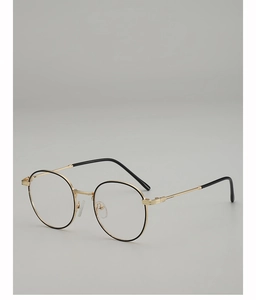 Detail of round gold metal frame glasses with black trim and clear nose pads