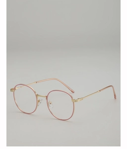 Macro detail of round gold and pink metal eyeglasses frame with polished finish