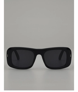 Detail of square black glossy sunglasses featuring decorative silver metal studs on the frame