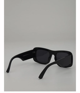 Detail view of thick black frame sunglasses showing the temple model code ZN3932
