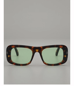 Detail of tortoiseshell rectangle sunglasses with light green lenses and silver arrow studs