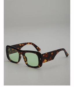 Close-up of tortoise square frame sunglasses with light green transparent lenses