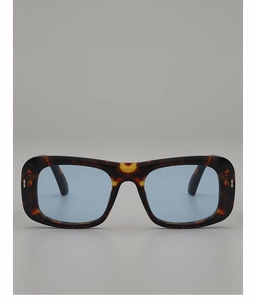 Macro detail of tortoiseshell square sunglasses with blue lenses and silver metal rivets