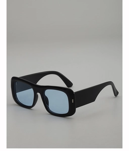 Detail of square black sunglasses with light blue lenses and thick temple arms