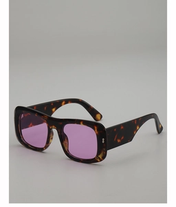 Detail of tortoise shell square sunglasses with purple lenses and silver rivet accents