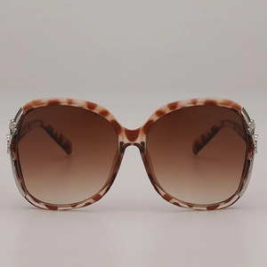 Oversized tortoise shell sunglasses with gradient brown lenses and flower metal detail