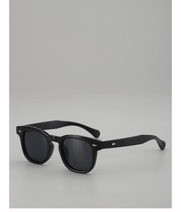 Detail of retro round black sunglasses with silver diamond studs and thick acetate frames