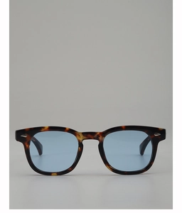 Detail of round tortoiseshell frames with blue lenses and silver diamond rivets