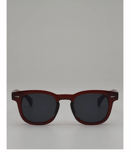 Close-up of deep red translucent round frames with silver diamond-shaped metal rivets