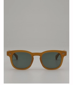Detail of amber tortoiseshell round frame sunglasses with metallic rivet accents