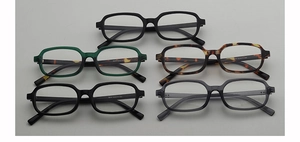 Detailed flat lay of small square sunglasses in black, tortoiseshell, and grey colors