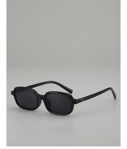 Detailed side view of vintage black square sunglasses with silver rivet accents