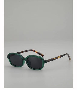 Detailed side view of small square sunglasses with green frames and leopard print temples