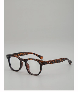 Macro detail of tortoiseshell glasses frame with silver diamond metal rivets decoration