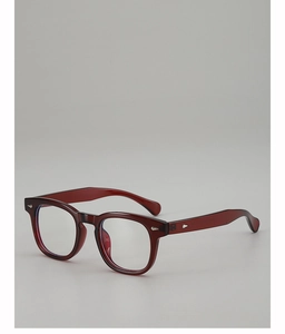 Detail shot of vintage dark red round frames featuring elegant silver arrow-shaped rivets