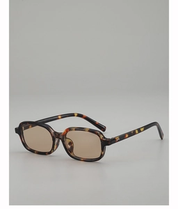 Detail view of square tortoiseshell sunglasses with brown lenses and sleek frame design