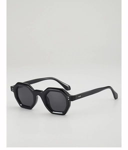 Detail of black geometric hexagonal sunglasses frame with polished finish and silver rivets