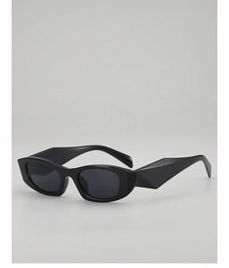Angled view of black cat-eye sunglasses featuring modern faceted thick frame temples