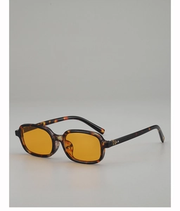 Detailed macro view of tortoiseshell square frame sunglasses with yellow tinted lenses