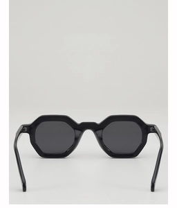 Front view of black octagonal geometric sunglasses with dark grey lenses on grey background