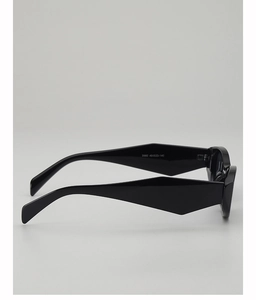 Side view of black cat-eye sunglasses featuring wide geometric temples and sleek frame
