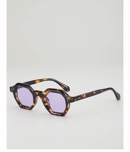 Macro detail of tortoiseshell hexagonal sunglasses with translucent purple lenses