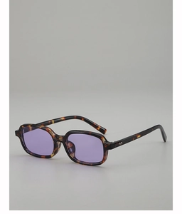 Detail of tortoiseshell square sunglasses with light purple lenses and metal rivets