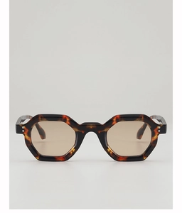 Detailed view of vintage tortoiseshell sunglasses with double metal rivets and tinted lenses