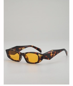 Detail of retro cat-eye sunglasses with tortoiseshell frames and orange tinted lenses