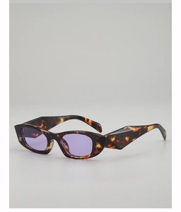 Detail of tortoise shell frame cat-eye sunglasses with purple lenses and geometric temples