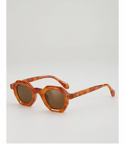 Detailed close-up of tortoise shell geometric sunglasses with metal rivet hinges