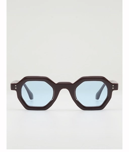 Close-up of geometric hexagonal sunglasses with dark frames and light blue tinted lenses