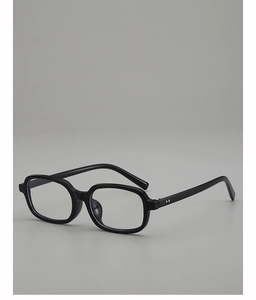 Close-up of black square frame sunglasses with metallic dot rivets and glossy finish