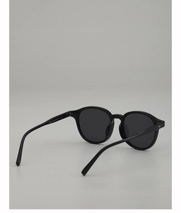 Close-up of vintage oval sunglasses frame with silver rivets and polished finish