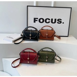 Detailed display of four retro crossbody bags in black, brown, burgundy, and green tones