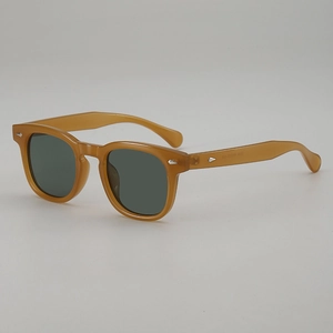 Vintage round amber frame sunglasses with classic silver rivet studs and dark lenses