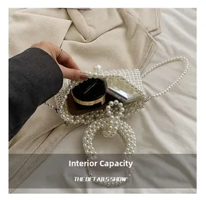 Detail shot showing the interior capacity of a white pearl woven handbag with makeup items