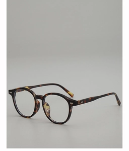 Close-up of vintage oval tortoiseshell eyewear frames with classic silver rivet details