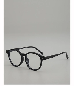 Detail view of vintage oval sunglasses with black frames and metallic hinge accents
