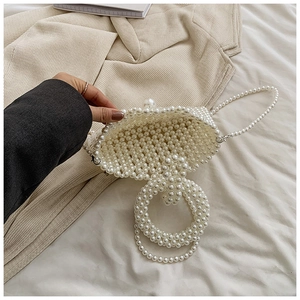 Detail of handmade pearl beaded handbag showing texture and inner weaving capacity