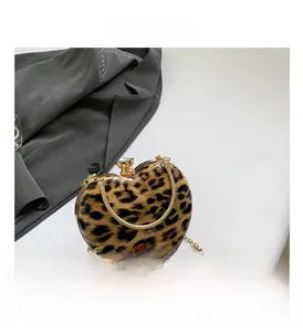 Detail of leopard print heart-shaped handbag with gold chain and crystal buckle